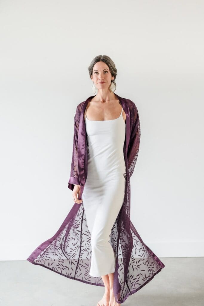 Woman walking towards camera in flowing silk kimono and slip dress showcasing fabric texture