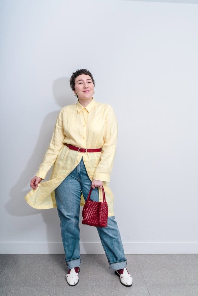Full length brand photoshoot portrait of a woman in a yellow belted shirt dress
